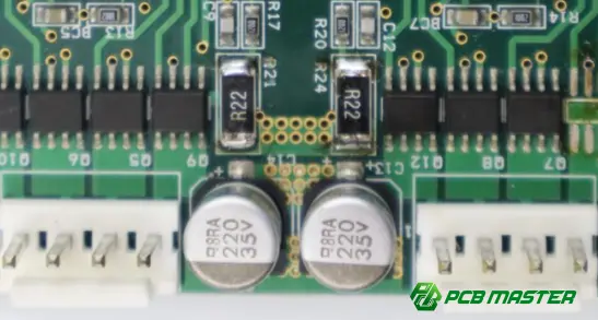 Capacitor mounted on a printed circuit board (PCB) for energy storage and power filtering in electronic circuits